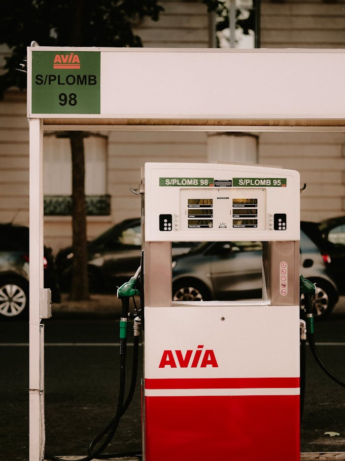 Retro-style gas pump at Avia station, capturing nostalgic feel with cars in the background.
